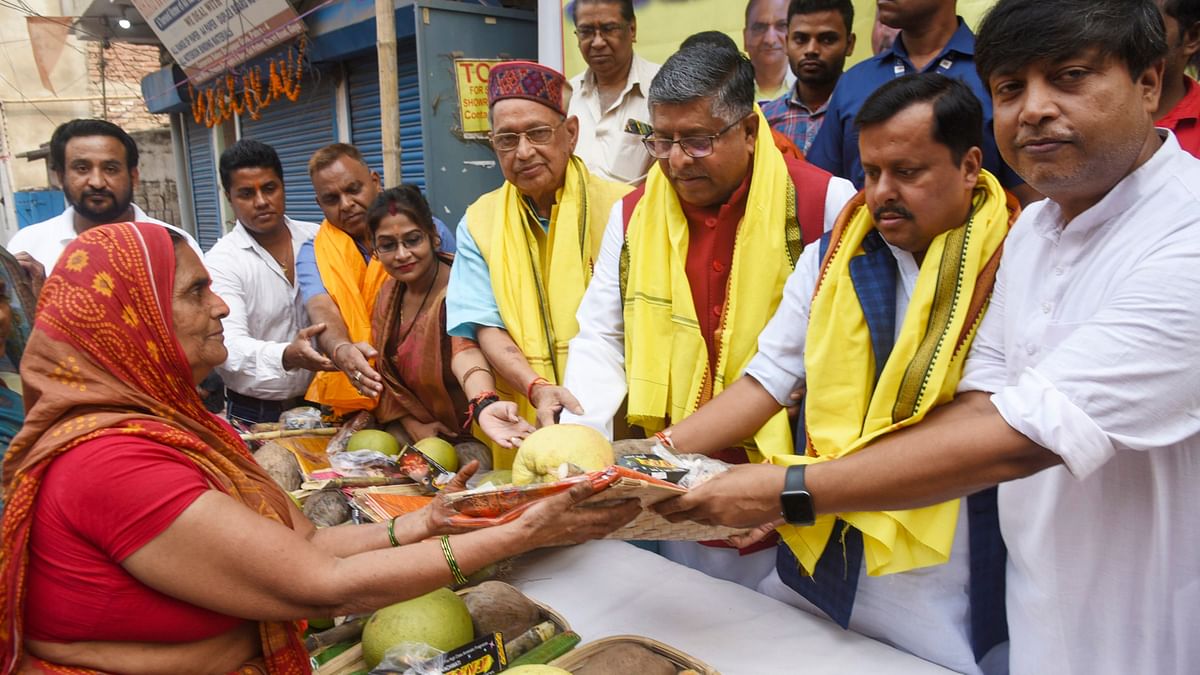 BJP MP Ravi Shankar Prasad with others distributes puja materials to women during the start of the 4-day Chhath Puja festival, in Patna.