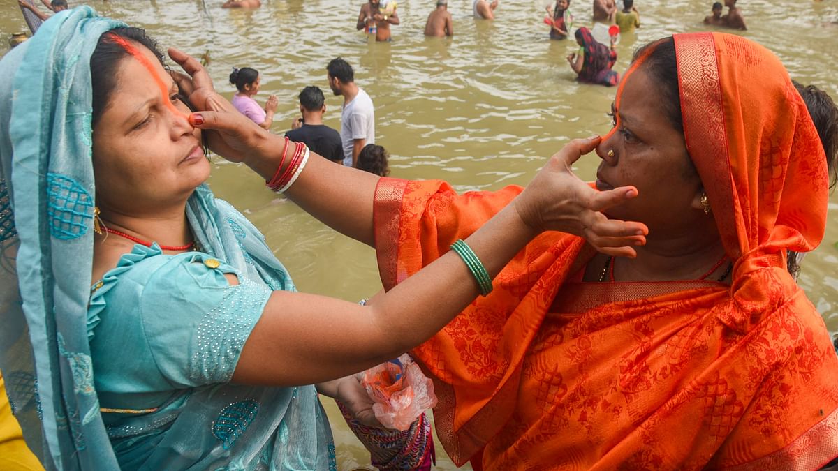 Devotees perform ritual after taking a holy dip in the Ganga river during the start of the 4-day Chhath Puja festival, in Patna.