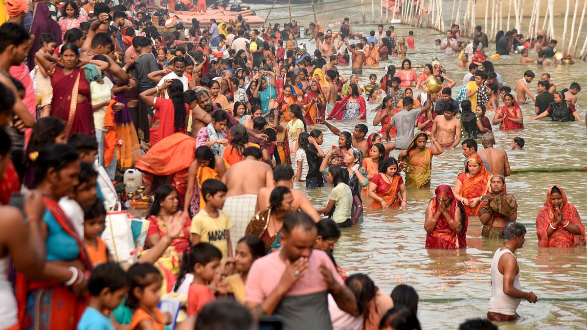 Devotees take a holy dip in Ganga river during the start of the 4-day Chhath Puja festival, in Patna.