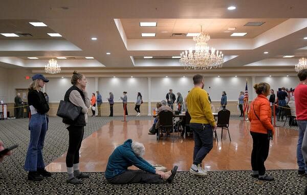 On November 5, 2024, on voting day in Portland, Maine, during the 2024 U.S. presidential election, people lined up at the Italian Heritage Center in Maine's 2nd Congressional District for more than an hour starting at 7 a.m. and waiting to be seated. A woman stretches while waiting to vote. 2024.