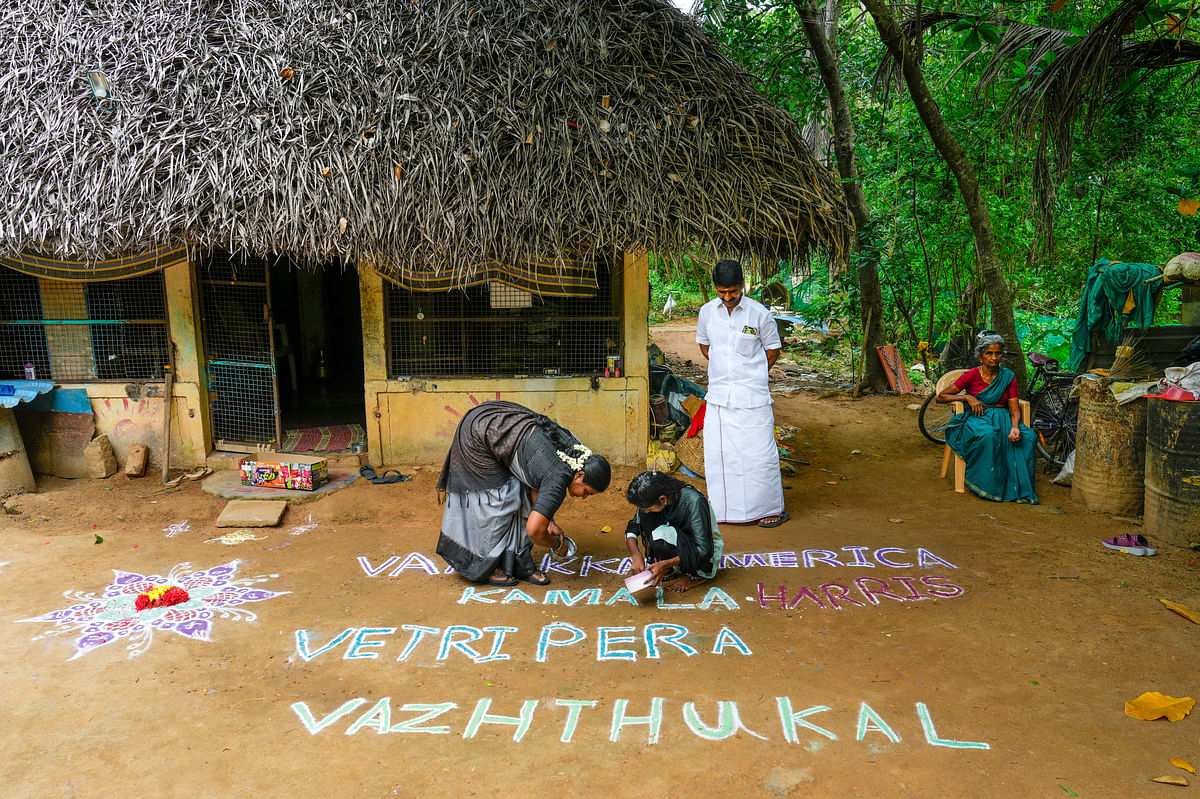 People prepare a kolam, a floor drawing made from coloured powder, that translates to "Greeting America, Our Wishes For Kamala Harris Victory" ahead of the US presidential election, at her ancestral village, Thulasendrapuram, in Thiruvarur district, Tuesday, Nov. 5, 2024. 