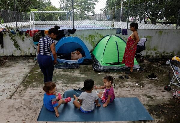 Migrant caravan stops to rest on its way to the US border, in Escuintla