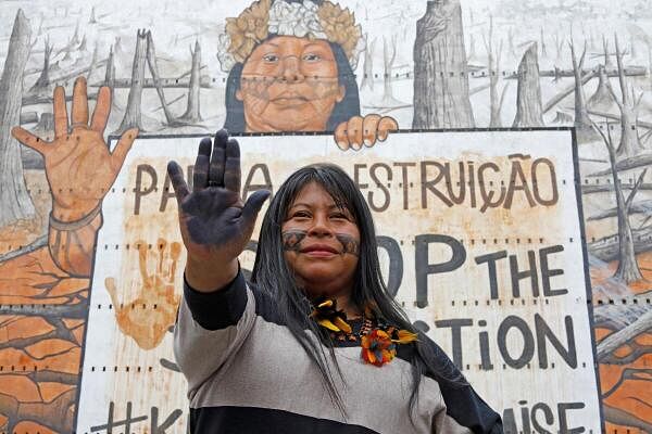 Indigenous leader Alessandra Munduruku, who received Goldman Environmental Prize in 2023 for her successful campaign to stop multinational mining companies prospecting on her tribe's ancestral lands in the Amazon, poses in front of the mural "Stop the Destruction" by Brazilian artist Mundano, depicting herself in Sao Paulo, Brazil.