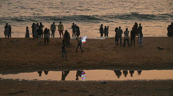 People visit Shanghumugham beach during sunset, in Thiruvananthapuram.