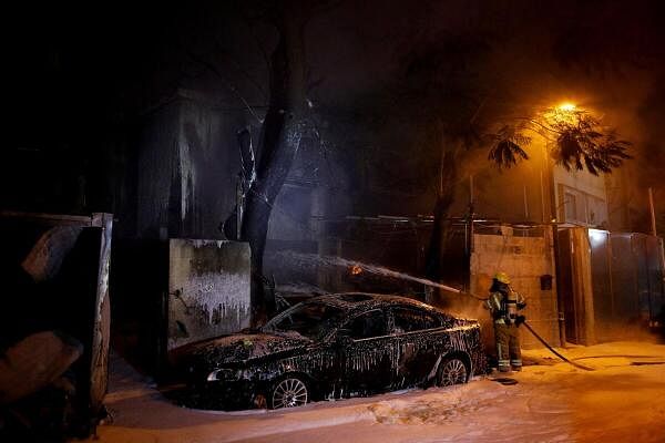 A firefighter works at the scene where a projectile fell after projectiles were launched from Lebanon, amid ongoing hostilities between Hezbollah and Israel, in Kiryat Ata, northern Israel.