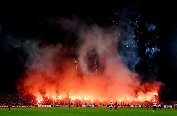 Fans with flares in the stands.