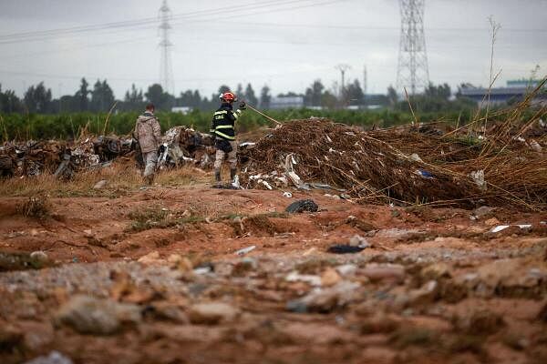 A soldier searches for bodies following rain and flash floods that caused rivers to overflow in Valencia and other parts of Spain, in the Poyo ravine in Quart de Poblet, Valencia, Spain.