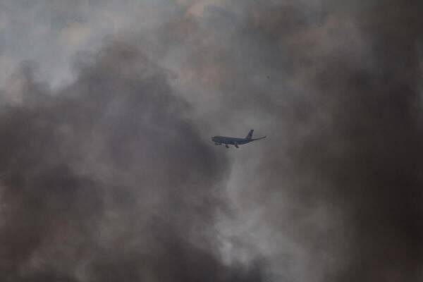 A MEA aircraft flies over Beirut's southern suburbs as it approaches Beirut-Rafic Hariri International Airport