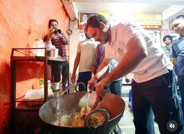 LoP in Lok Sabha and Congress MP Rahul Gandhi prepares 'poha' at a stall during an election campaign ahead of the Maharashtra Assembly elections, in Nagpur, Maharashtra, Saturday, Nov. 16, 2024.