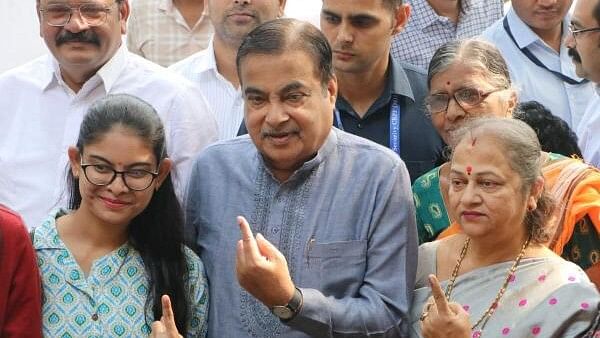 Union Minister Nitin Gadkari and his family members show their fingers marked with indelible ink after casting votes during the Maharashtra Assembly elections, in Nagpur, Wednesday, Nov. 20, 2024.