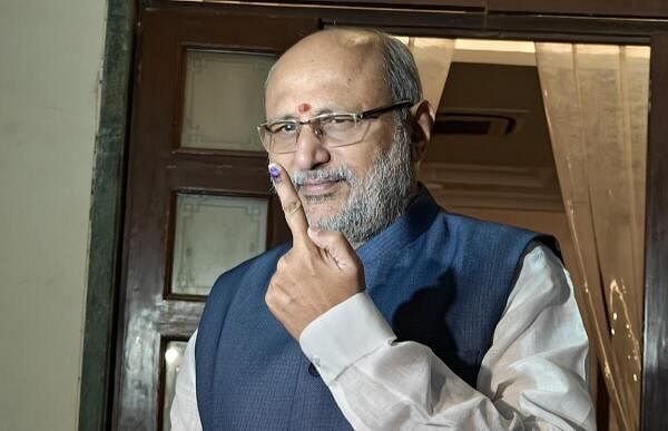 Maharashtra Governor CP Radhakrishnan shows his finger marked with indelible ink after casting vote at Raj Bhavan during the Maharashtra Assembly elections, in Mumbai.