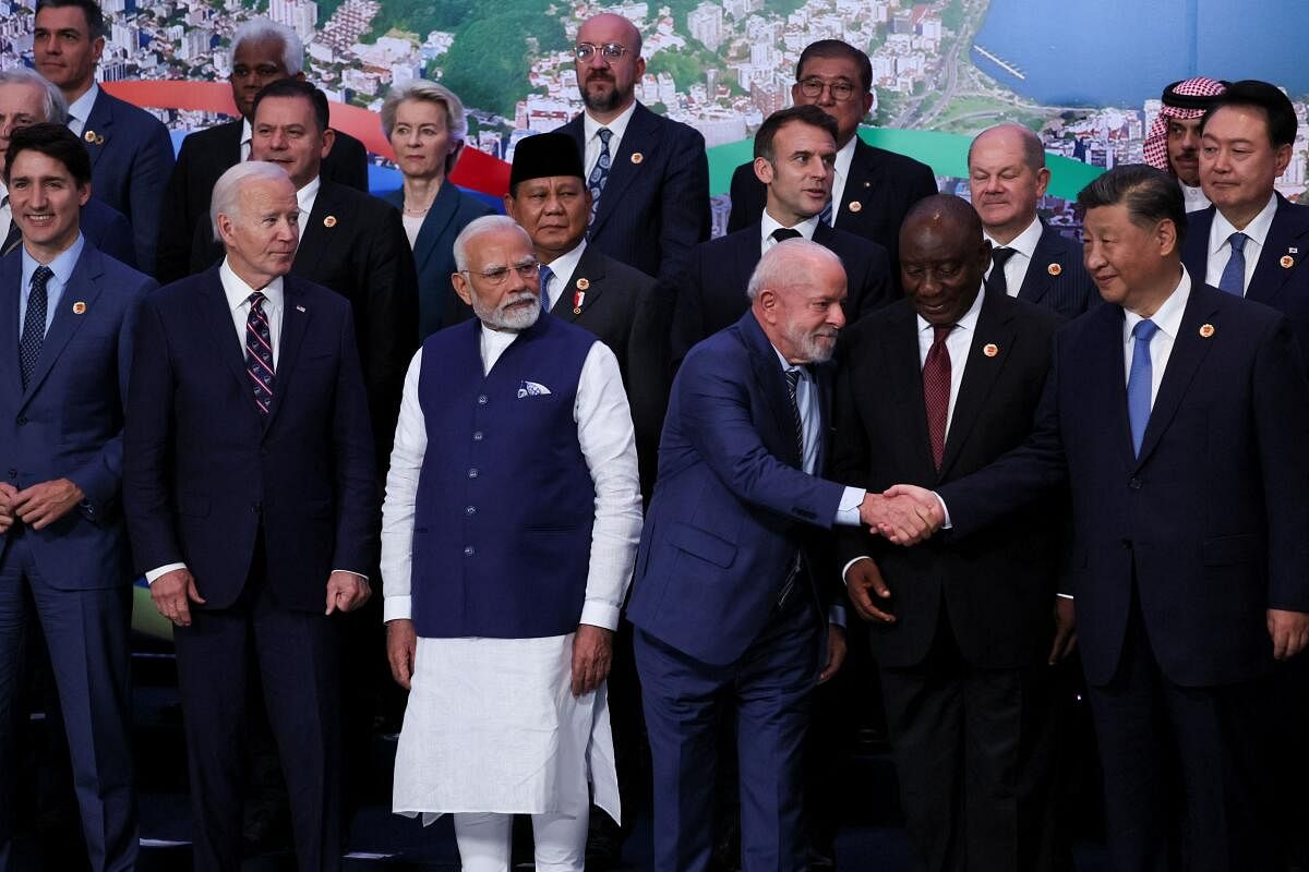 U.S. President Joe Biden, Indian Prime Minister Narendra Modi, Canada's Prime Minister Justin Trudeau, South Africa's President Cyril Ramaphosa, French President Emmanuel Macron, European Commission President Ursula von der Leyen, European Council President Charles Michel look on, as Brazil's President Luiz Inacio Lula da Silva shakes hands with China's President Xi Jinping, while world leaders gather for a group photo during the G20 summit in Rio de Janeiro, Brazil, November 19, 2024.