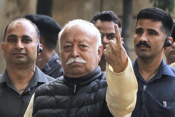 RSS chief Mohan Bhagwat shows his finger marked with indelible ink after casting vote during the Maharashtra Assembly elections, in Nagpur.