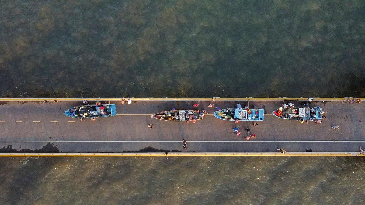 A drone view of fishermen pushing boats on the fishermen's pier at the port of La Libertad, financed by China, in La Libertad, El Salvador, November 20, 2024.