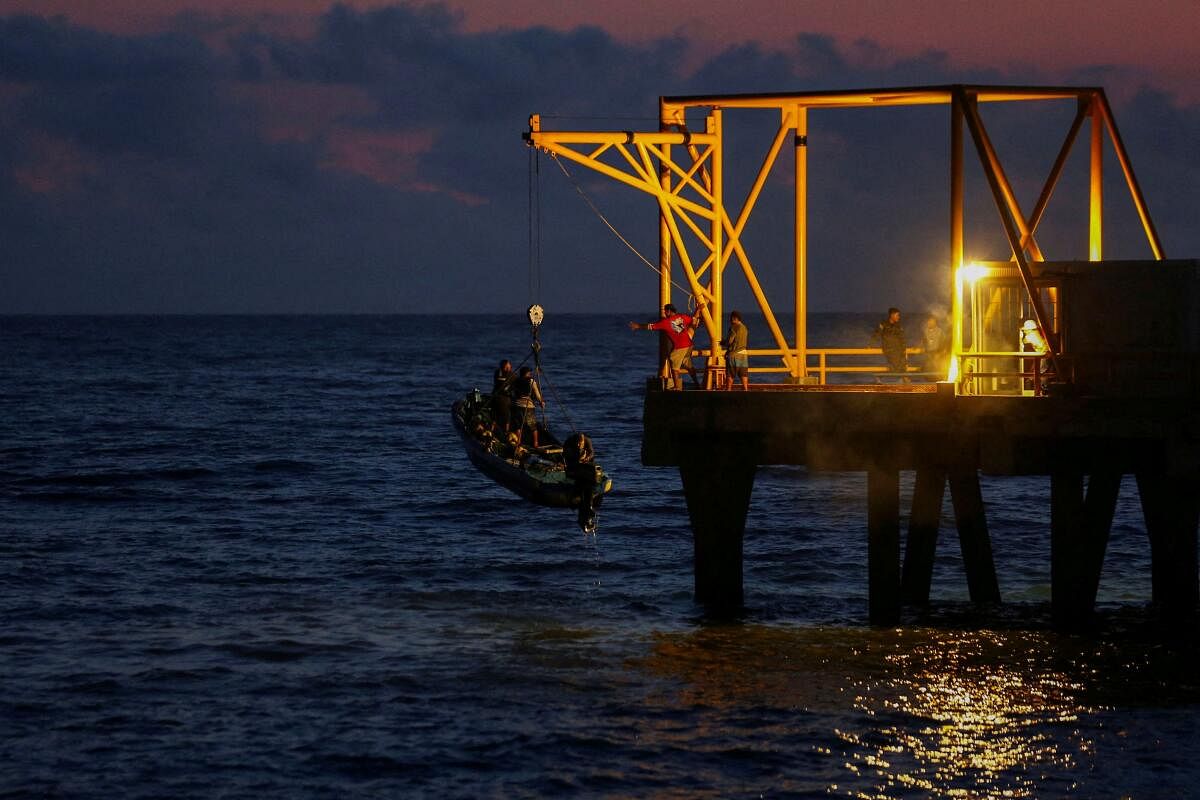 Fishermen pull a boat out of the water on the fishermen's pier at the port of La Libertad, financed by China, in La Libertad, El Salvador, November 20, 2024.