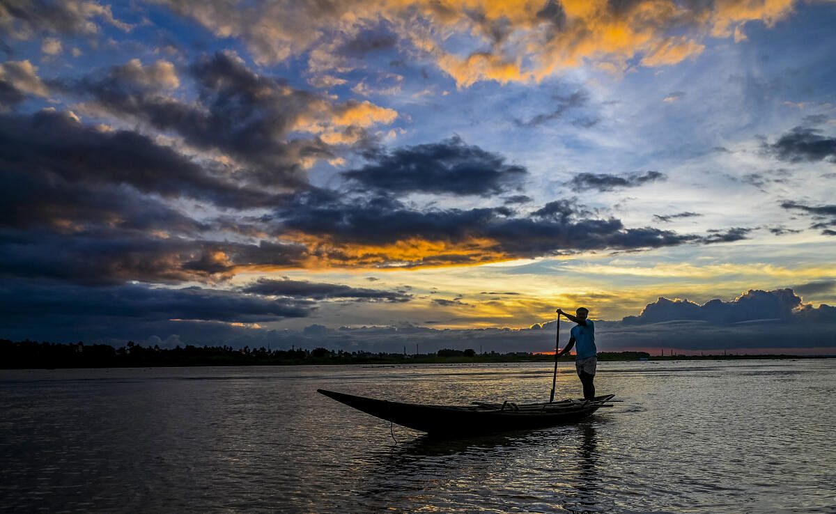 A fisherman rows his boat during sunset, in Nadia district of West Bengal, Thursday, Nov. 21, 2024. Nov. 21 is observed as World Fisheries Day.