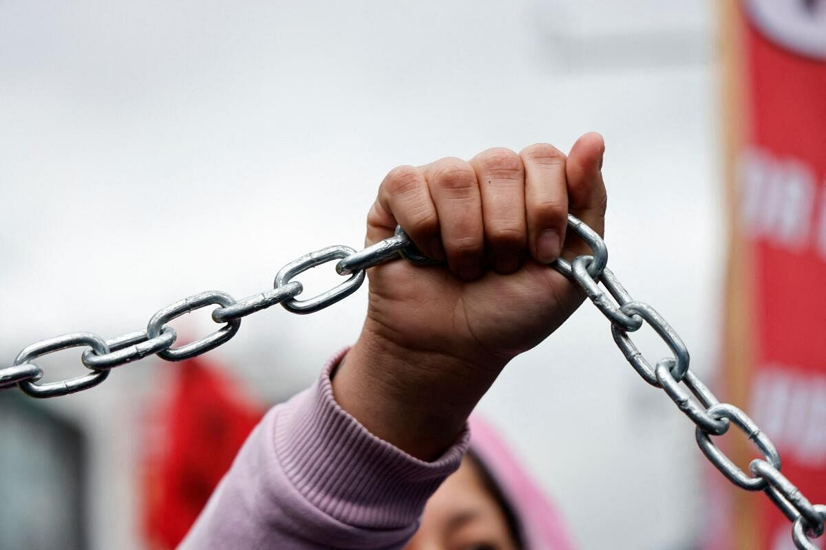 A demonstrator holds a chain during a march against the government of Ecuador's President Daniel Noboa, who is seeking re-election in 2025, but has struggled to tamp down crime and manage an ongoing energy crisis, in Quito, Ecuador November 21, 2024.