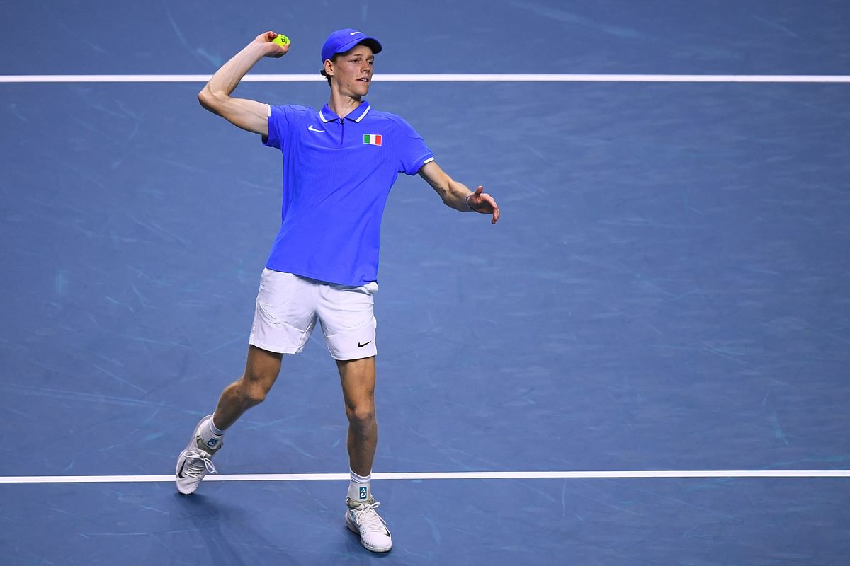 Jannik Sinner of Team Italy throws a ball to the public after beating Sebastian Baez of Team Argentina during their quarter-final singles match between Italy and Argentina at the Davis Cup Finals at the Palacio de Deportes Jose Maria Martin Carpena arena in Malaga southern Spain on November 21 2024. (Photo by JORGE GUERRERO / AFP)