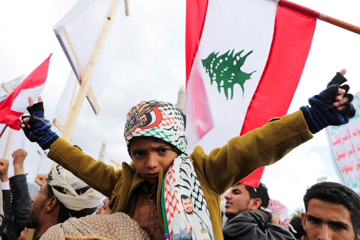 A child gestures as protesters, mainly Houthi supporters, rally to show support to Lebanon's Hezbollah and Palestinians in the Gaza Strip, in Sanaa, Yemen, November 22, 2024.