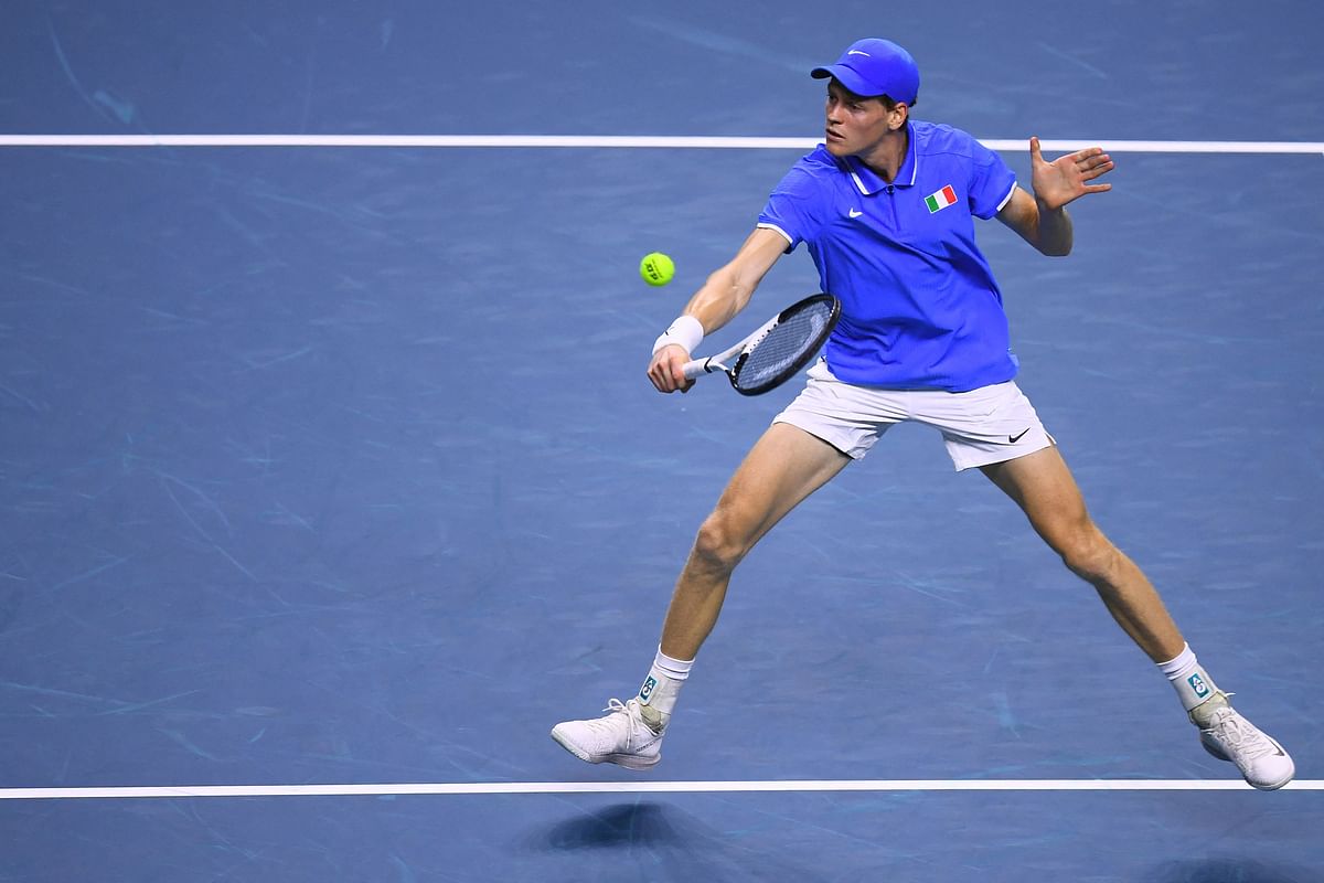 Jannik Sinner of Team Italy returns the ball to Sebastian Baez of Team Argentina during their quarter-final singles match between Italy and Argentina at the Davis Cup Finals at the Palacio de Deportes Jose Maria Martin Carpena arena in Malaga southern Spain on November 21 2024. (Photo by JORGE GUERRERO / AFP)