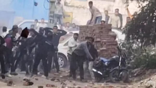 Locals pelt stones at security personnel during a second survey of the Jama Masjid, claimed to be originally the site of an ancient Hindu temple, in Sambhal, Sunday, Nov. 24, 2024.