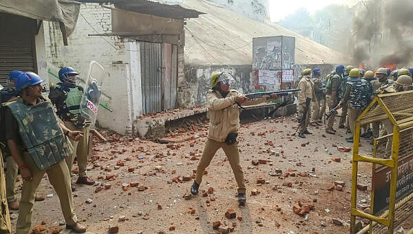 Police try to control the situation amid violence during a second survey of the Jama Masjid, claimed to be originally the site of an ancient Hindu temple, in Sambhal, Sunday, Nov. 24