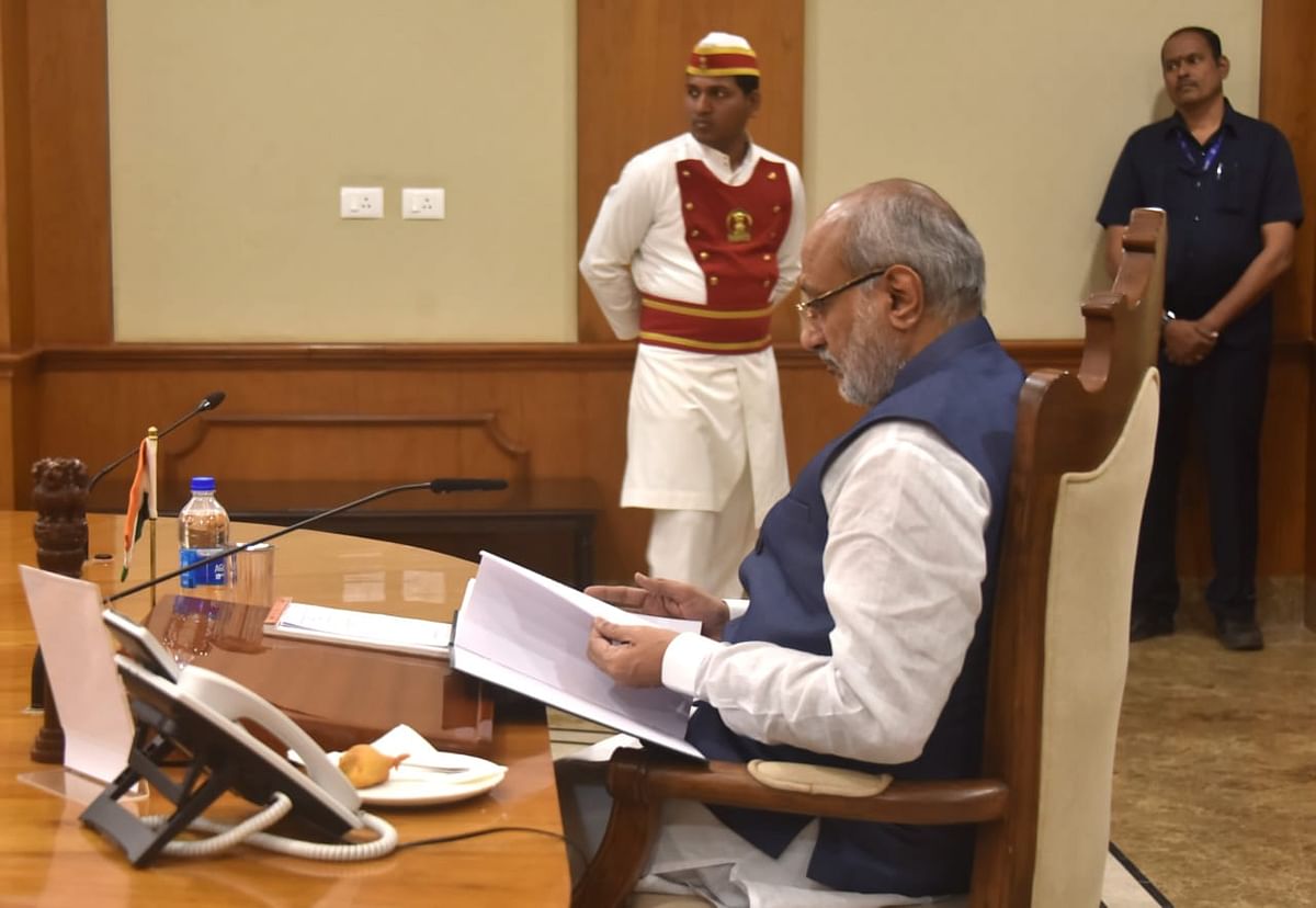 Maharashtra Governor C P Radhakrishnan looks over the Maharashtra Government State Gazette with the names of elected candidates