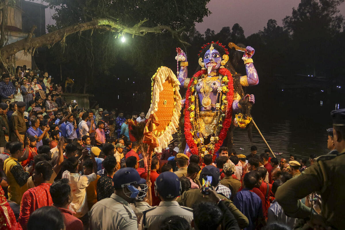 Devotees take part in the immersion procession of Goddess Kali idol on the last day of Raksha Kali puja at Balurghat in Dakshin Dinajpur district of West Bengal.