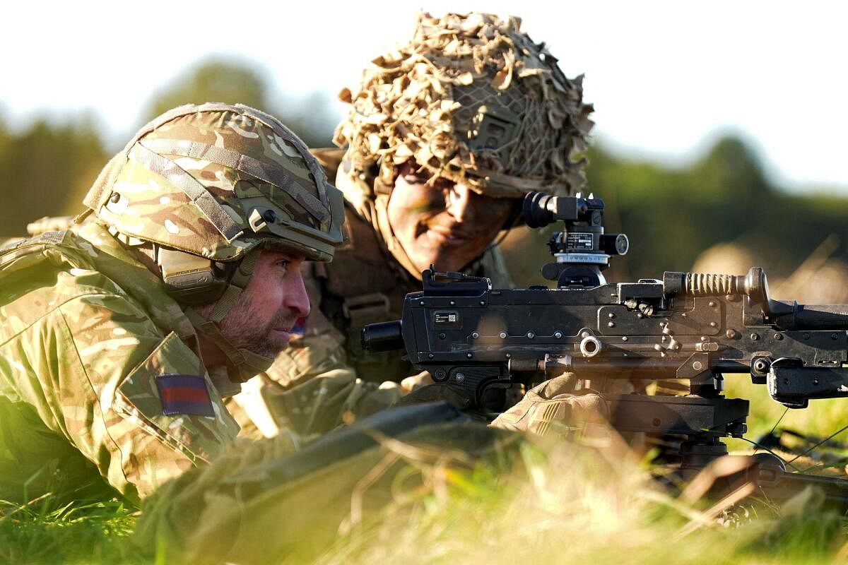 Britain's Prince William, Colonel of the Welsh Guards, holds a general-purpose machine gun (GPMG) during a visit to the 1st Battalion Welsh Guards at Salisbury Plain, Britain.