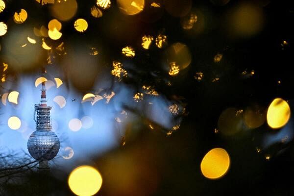 The Television Tower is seen through lights decorating an illuminated tree in Berlin, Germany.