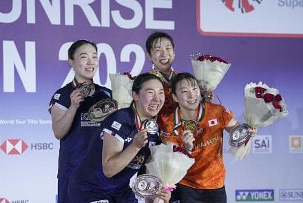 Japan's Arisa Igarashi and Ayako Sakuramoto, in orange, and South Korea's Kim Hye Jeong and Kong Hee Yong, pose for pictures during the felicitation ceremony after finishing as winners and runner-up respectively, of the Women's Doubles final match at the India Open 2025 badminton tournament, in New Delhi, Sunday, Jan. 19, 2025.