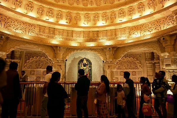 The followers gather to see a replica of the Ayodaya Ram temple during the Mahakam Mela, which is currently underway in Prayagraj, Uttar Pradesh