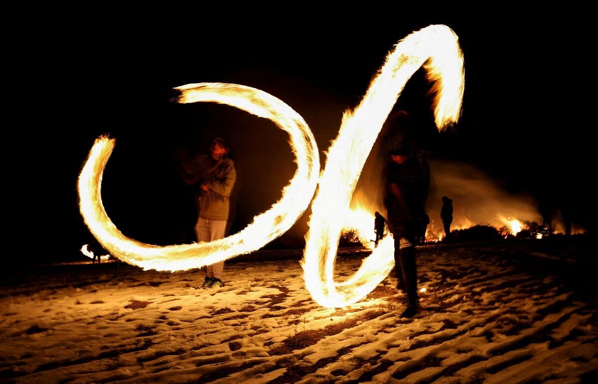 Children spin rings of fire during rituals in celebration of Mesni Zagovezni, the second Sunday before Great Lent, in Lozen, Bulgaria