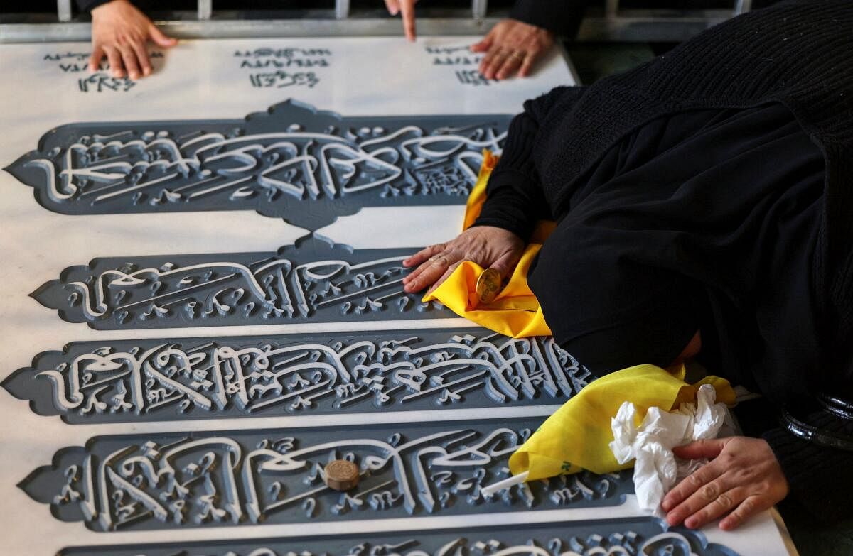 A woman reacts as she visits the burial site of former Hezbollah leader Hassan Nasrallah, who was killed during an Israeli airstrike in Beirut last year, on the outskirts of Beirut, Lebanon