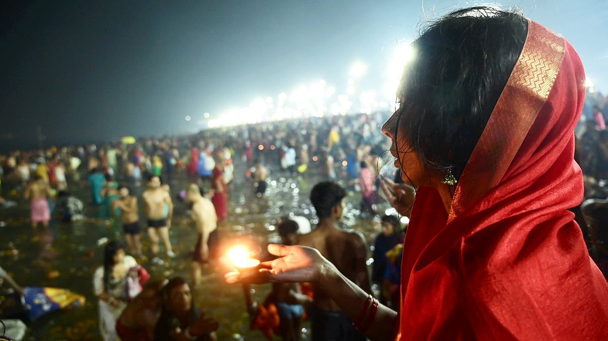 A devotee prays after taking a holy dip in the Ganga river on the occasion of the Maha Shivratri festival during the ongoing Maha Kumbh Mela 2025 in Prayagraj.