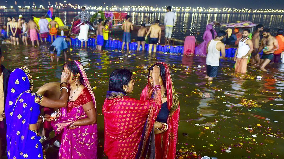 Devotees perform rituals after taking a holy dip in the Ganga river on the occasion of the Maha Shivratri festival during Maha Kumbh Mela 2025 in Prayagraj.
