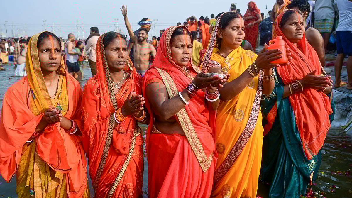Devotees perform rituals as they take a holy dip at Sangam on the occasion of Maha Shivratri during the Maha Kumbh Mela 2025 in Prayagraj.