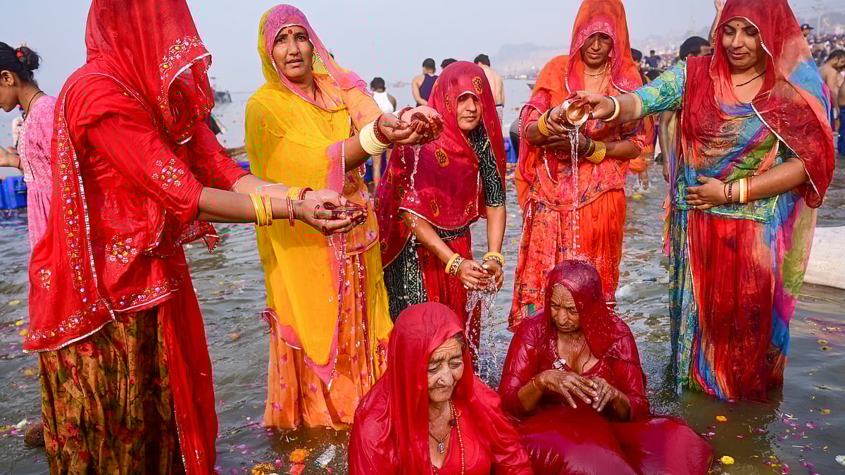 Devotees from Rajasthan perform rituals as they take a holy dip at Sangam on the occasion of Maha Shivratri during the Maha Kumbh Mela 2025 in Prayagraj.