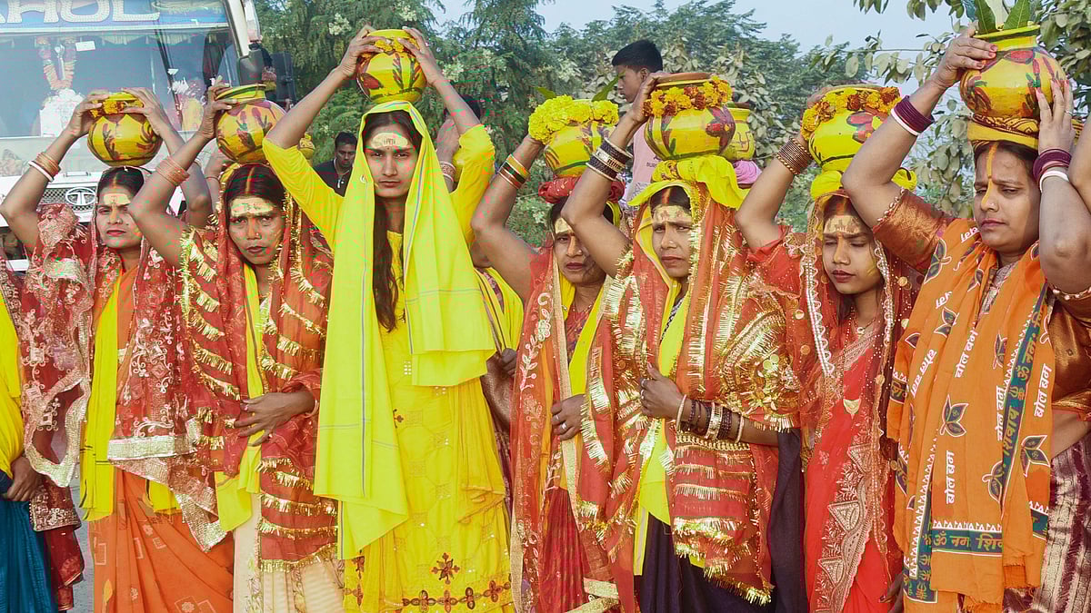 Devotees carrying 'kalash' arrive to take a holy dip in the Ganga river on the occasion of Maha Shivratri in Patna.