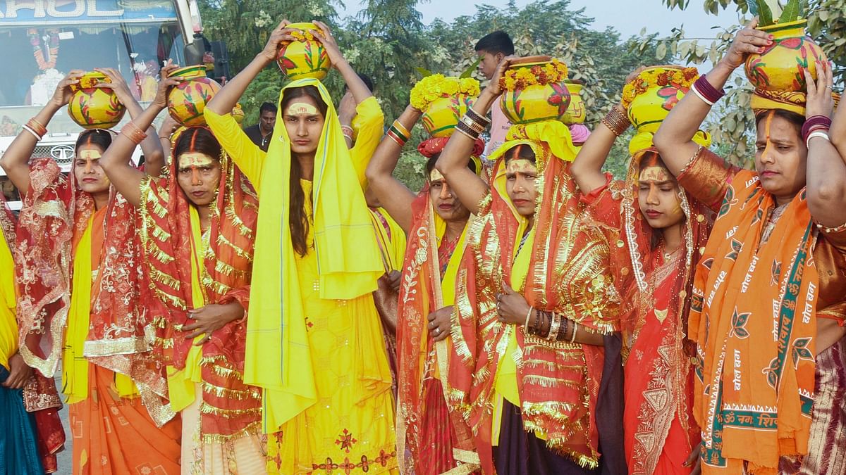 Devotees carrying 'kalash' arrive to take a holy dip in the Ganga river on the occasion of Maha Shivratri in Patna.