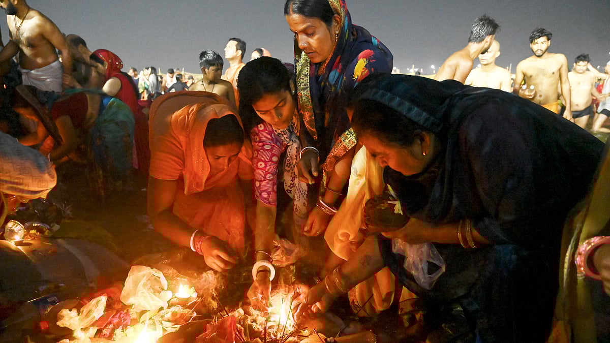 Devotees perform rituals after taking a holy dip in the Ganga river on the occasion of the Maha Shivratri festival during the ongoing Maha Kumbh Mela 2025 in Prayagraj.