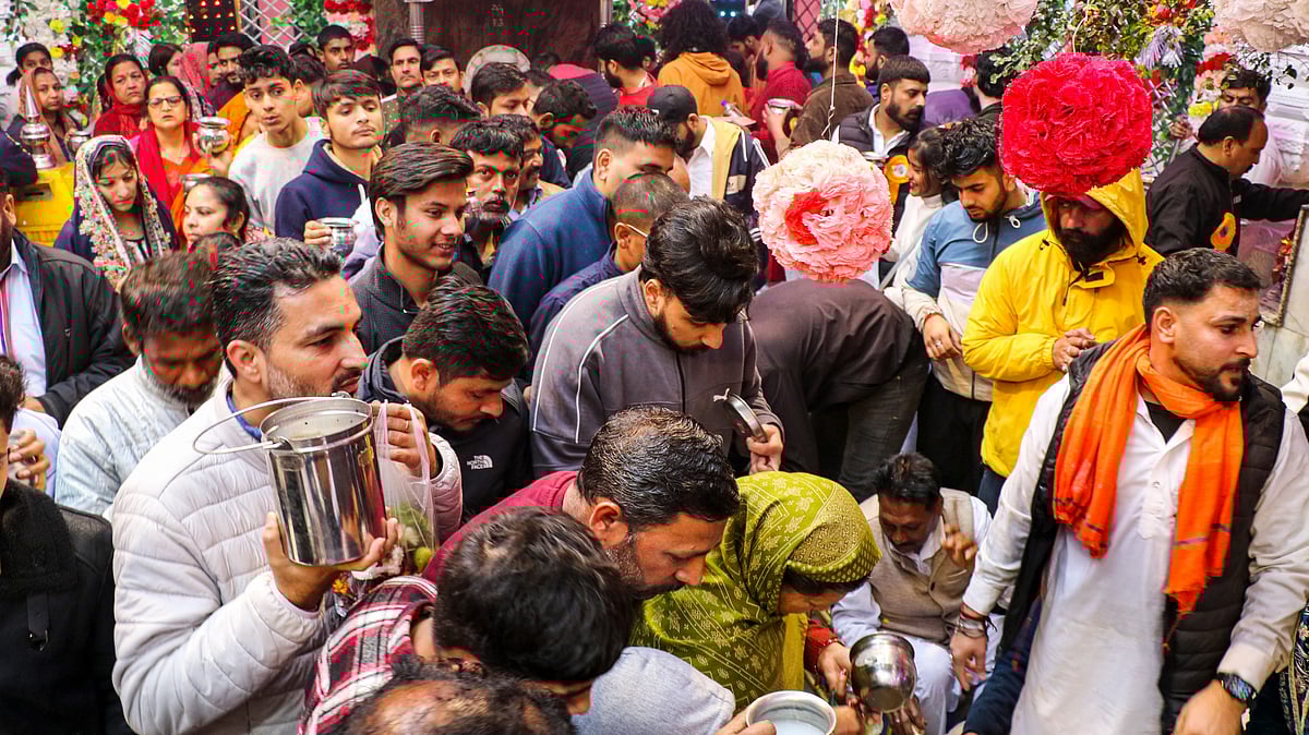 Hundreds of devotees wait at a temple to offer milk on the Maha Shivratri festival in J&amp;K.