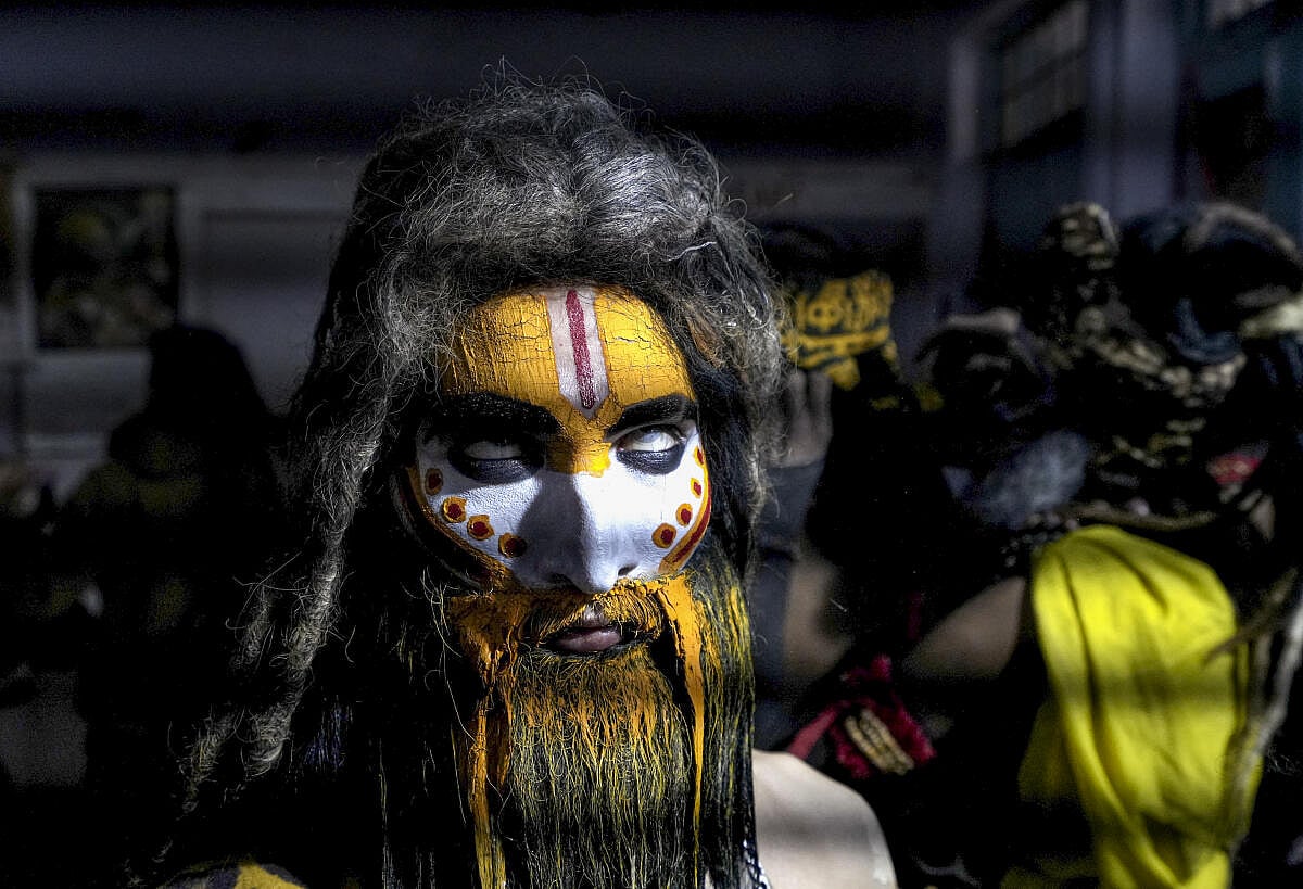 A devotee takes part in a religious procession on the eve of Maha Shivratri festival, in Amritsar