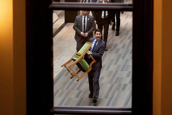 Canada's Prime Minister Justin Trudeau carries his chair from the House of Commons on Parliament Hill in Ottawa, Ontario, Canada, March 10, 2025.