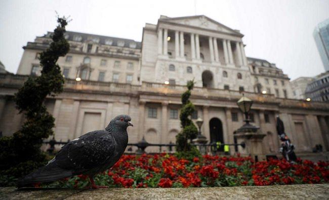 A pigeon stands in front of the Bank of England in London, Britain. Reuters Photo