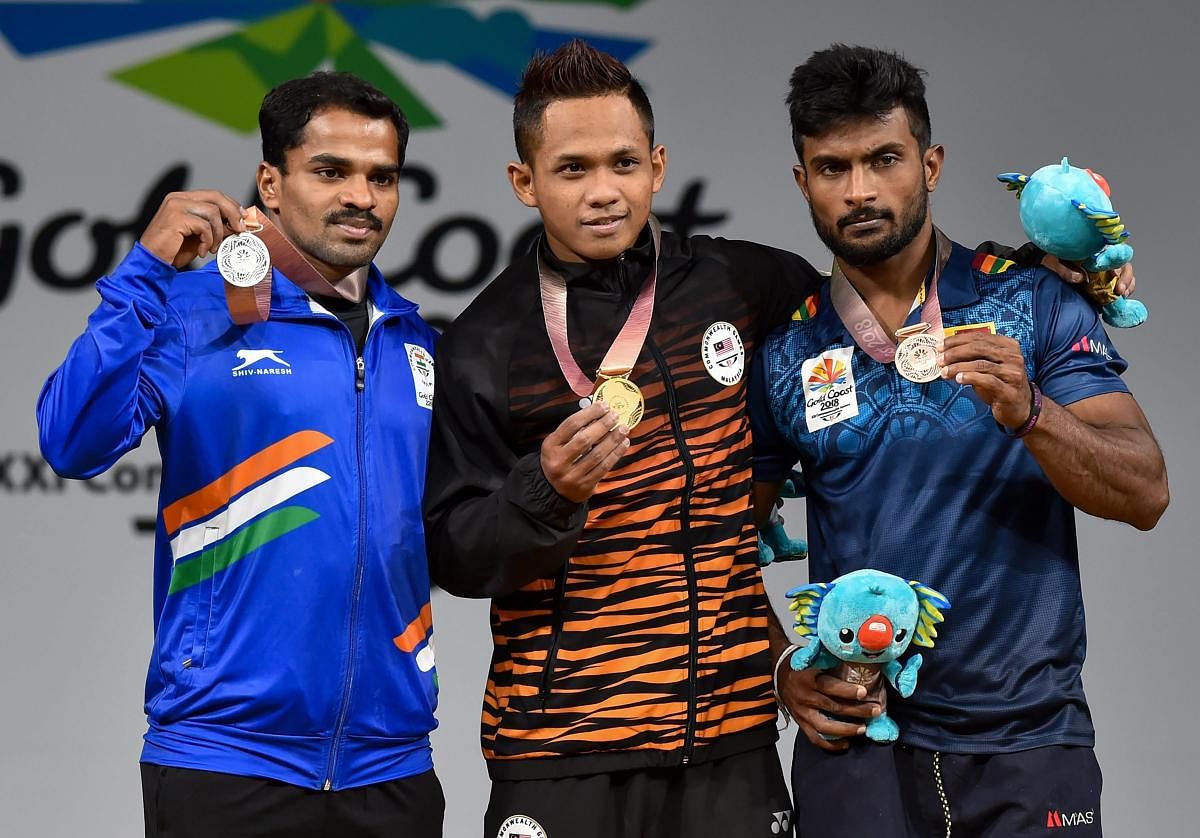 Silver medalist Indian weightlifter P Gururaja, Gold medalist Malaysia's Muhammad Izhar Ahmad and Bronze medalist Sri Lanka's Chaturanga Lakmal pose for a photo during the medal ceremony of men's 56kg weightlifting category during the Commonwealth Games 2018 in Gold Coast, on Thursday. (PTI Photo)
