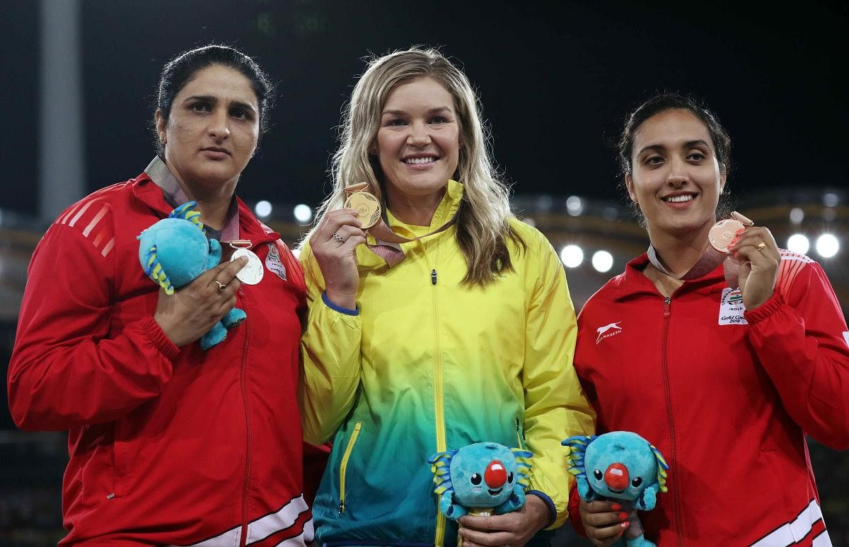 Gold medalist Dani Stevens of Australia, silver medalist Seems Punia of India and bronze medalist Navjeet Dhillon of India on the podium. (REUTERS)