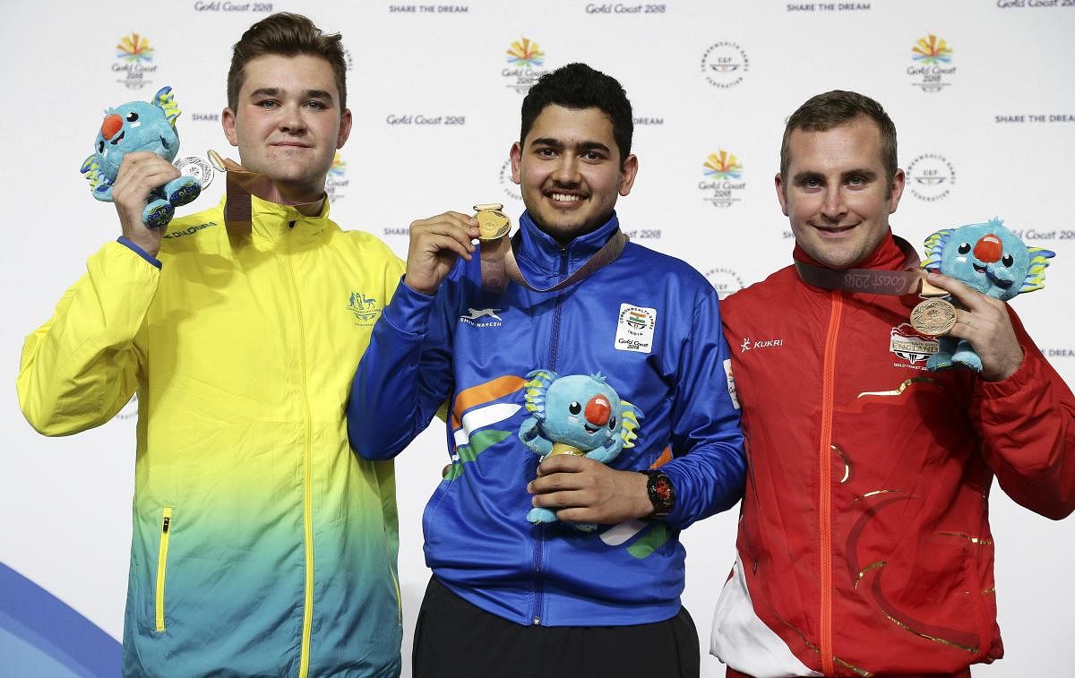 Sergei Evglevski of Australia, left, silver medal, Anish of India, center, gold medal, and Sam Gown of England, right, bronze medal, during the men's 25m Rapid Fire Pistol final at the Belmont Shooting Centre during the 2018 Commonwealth Games in Brisbane, Australia, Friday, April 13, 2018. (AP/PTI Photo)