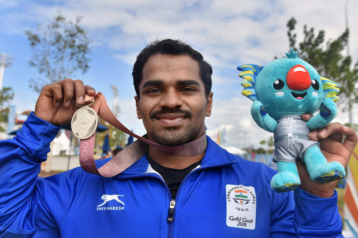 Indian weightlifter P Gururaja poses for a photo after winning silver in Men's 56kg Weightlifting final during Commonwealth Games 2018 in Gold Coast on Thursday. (PTI Photo)