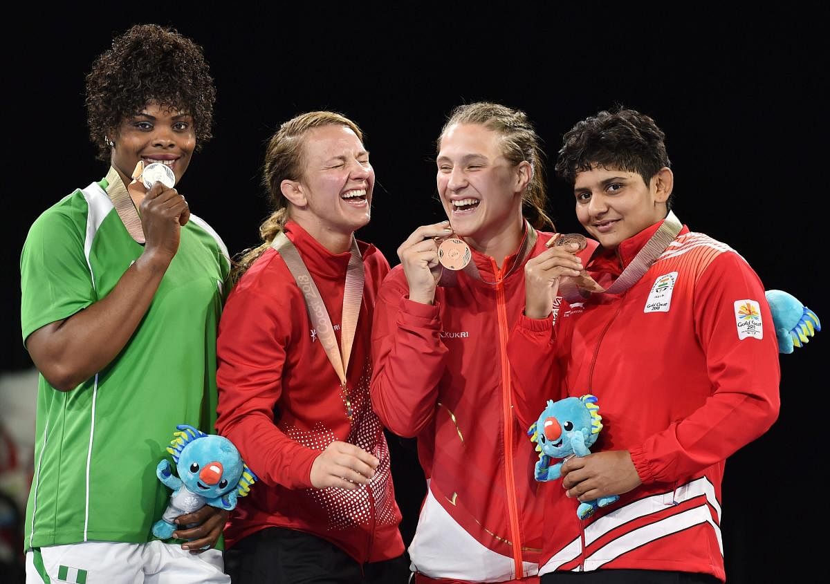 Gold medalist Erica Wiebe of Canada, silver medalist Blessing Onyebuchi of Nigeran, bronze medalists Kiran and Georgina Nelthorpe during the medal ceremony of the women’s freestyle 76kg category during the Commonwealth Games 2018 in Gold Coast, on Thursday. (PTI Photo)